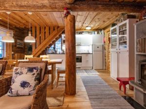 a kitchen and living room with a table and a fireplace at Holiday Home Tunturitorppa by Interhome in Äkäslompolo +10 photos