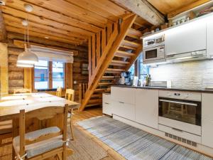 a kitchen and dining room with a wooden ceiling at Holiday Home Tunturitorppa by Interhome in Äkäslompolo