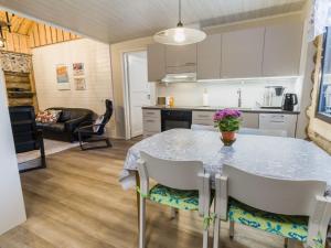 a kitchen and dining room with a table and chairs at Holiday Home Kantapää d2 by Interhome in Luosto +16 photos