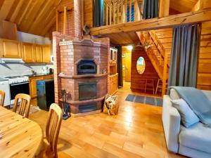 a living room with a wood stove in a cabin at Holiday Home Vuonkuma by Interhome in Äkäslompolo