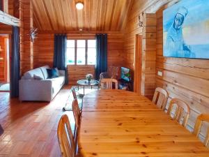 a dining room with a large wooden table and chairs at Holiday Home Vuonkuma by Interhome in Äkäslompolo