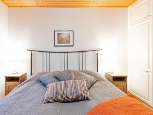 a bedroom with a bed with two night stands at Holiday Home Aamutähti by Interhome in Äkäslompolo