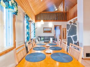 a dining room with a table and a couch at Holiday Home Aamutähti by Interhome in Äkäslompolo