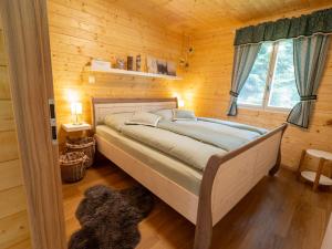 a bedroom with a bed in a wooden cabin at Geofond Chaty in Chotěboř +31 photos