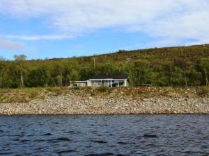 a house on the shore of a body of water at Holiday Home Karetörmä by Interhome in Nuorgam