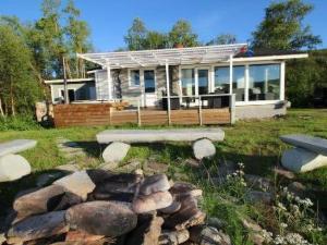 a house with a rock garden in front of it at Holiday Home Karetörmä by Interhome in Nuorgam