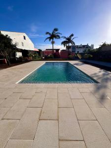 a swimming pool in the middle of a patio at Quinta do Rosário in Lagoa