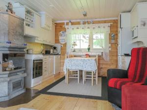 a kitchen and dining room with a table and a couch at Holiday Home Sipukka by Interhome in Meltaus +21 photos