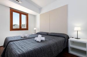 a bedroom with a bed with two pillows on it at Yourhouse Blau Blue 2 3 in Can Picafort