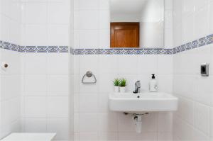 a white bathroom with a sink and a mirror at Yourhouse Blau Blue 2 3 in Can Picafort +35 photos