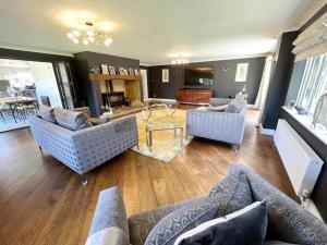 a living room with two couches and a table in it at Oak Valley Lodges & Camping in Pett