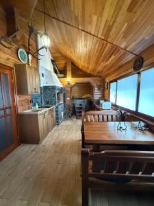a kitchen and dining room with a wooden ceiling at WOOD house in Skhidnitsa