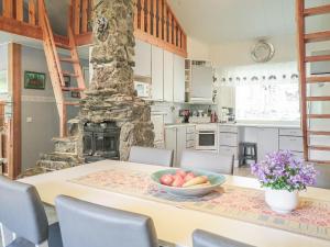 a kitchen with a table with a bowl of fruit on it at Holiday Home Kerkkälä by Interhome in Luosto
