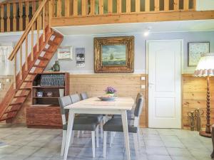 a dining room with a white table and chairs at Holiday Home Kerkkälä by Interhome in Luosto +19 photos