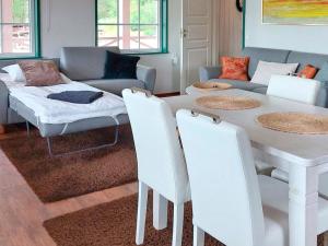 a living room with a white table and chairs at Holiday Home Villa blomvik by Interhome in Kristenäs
