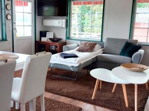 a living room with a couch and a table at Holiday Home Villa blomvik by Interhome in Kristenäs +14 photos