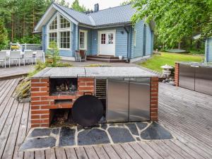 a house with a brick oven on a deck at Holiday Home Sointukallio by Interhome in Savonlinna