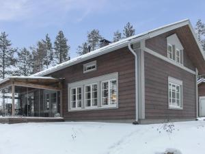 a house with snow in front of it at Holiday Home Seppola by Interhome in Ruka