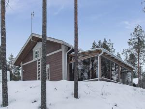 a house in the snow with trees at Holiday Home Seppola by Interhome in Ruka