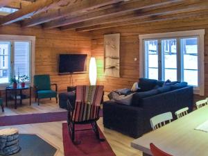 a living room with a couch and a tv at Holiday Home Seppola by Interhome in Ruka