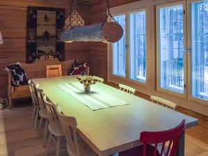 a dining room with a wooden table and chairs at Holiday Home Seppola by Interhome in Ruka +18 photos