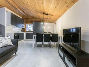 a kitchen and living room with a table and chairs at Holiday Home Honkakeko by Interhome in Levi