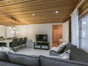 a living room with a couch and a television at Holiday Home Honkakeko by Interhome in Levi