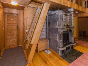 an empty room with a stone fireplace in a house at Holiday Home Ulpukka by Interhome in Savilahti +21 photos