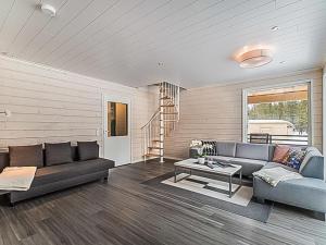 a living room with a couch and a table at Holiday Home Pallaskieppi by Interhome in Kyrö +20 photos