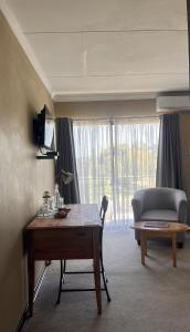 a living room with a table and a couch at The Anne Guest House in Maseru