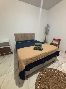 a bedroom with a bed with a stuffed animal on it at Cajuí da Vila Atins in Atins