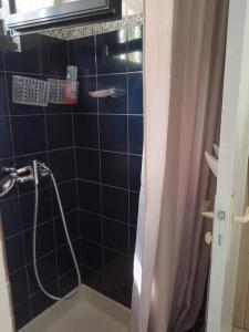 a black tiled shower with a shower curtain in a bathroom at Chez Béa in Lumio +27 photos