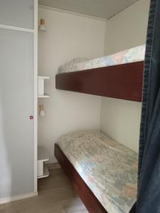 a bedroom with two bunk beds in a room at Chez Béa in Lumio