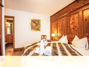 a bedroom with a bed with towels on it at Apartment Chesa Sonnalpine B 48-4 by Interhome in St. Moritz