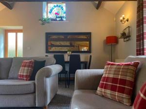 a living room with two couches and a table at Rivers Edge Cottage in Shotley Bridge +4 photos