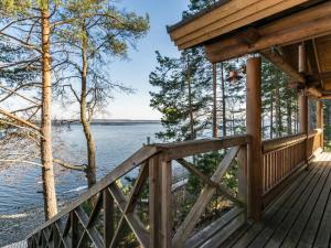 a porch of a cabin with a view of the water at Holiday Home Roopenranta by Interhome in Asikkala +23 photos