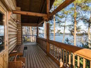 a porch of a cabin with a view of the water at Holiday Home Roopenranta by Interhome in Asikkala