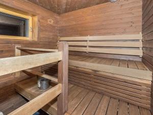 an empty sauna with wooden walls and wooden floors at Holiday Home Oriaho by Interhome in Iisalmi +19 photos