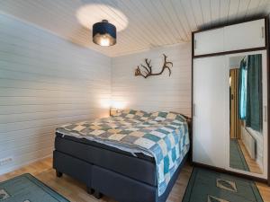 a bedroom with a bed and a mirror at Holiday Home Lomamaja 1 by Interhome in Raattama +16 photos