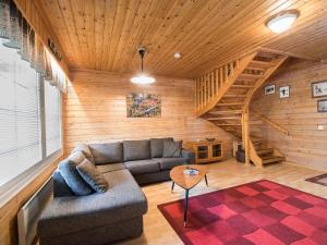 a living room with a couch and a wooden ceiling at Holiday Home Lomamaja 1 by Interhome in Raattama