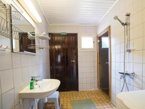 a bathroom with a sink and a mirror and a shower at Holiday Home Lomamaja 1 by Interhome in Raattama