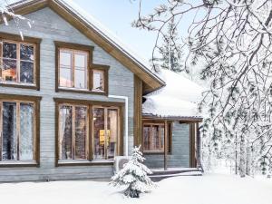a house in the snow with a christmas tree at Holiday Home Rome 10 by Interhome in Syöte