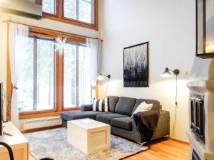 a living room with a couch and a fireplace at Holiday Home Rome 10 by Interhome in Syöte