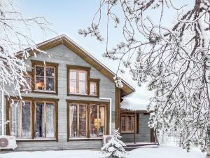 a house in the snow with snow covered trees at Holiday Home Rome 10 by Interhome in Syöte