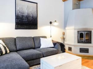 a living room with a couch and a fireplace at Holiday Home Rome 10 by Interhome in Syöte