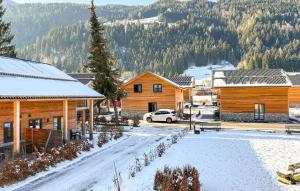 a snow covered town with wooden buildings and trees at Ferienwohnung 1 Stock in Afritz