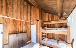 a room with two bunk beds in a wooden wall at Ferienwohnung 1 Stock in Afritz