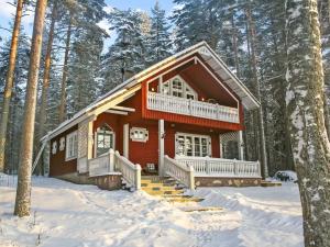 a log cabin in the woods in the snow at Holiday Home Honkaniemi by Interhome in Rasivaara