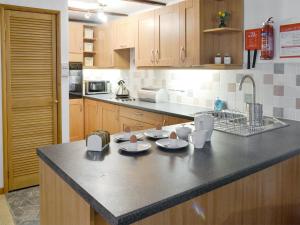 a kitchen with a counter with dishes on it at Clover Cottage in Keswick