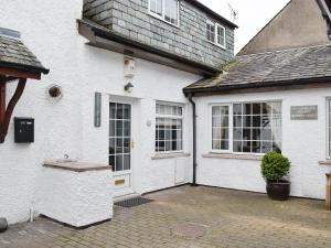a white house with a white door and windows at Clover Cottage in Keswick